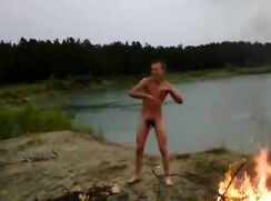 Naked boy dancing by the fire