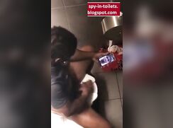 Spying a black wanker with a big dick in the Toilet