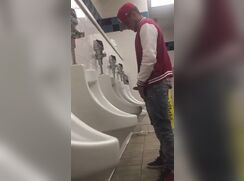 Hard on at urinal boy