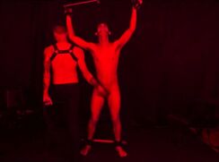 BDSM slave boy bound, whipped, balls cuffed weighted