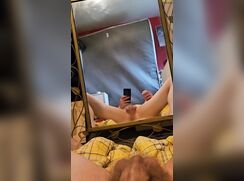 Jerking off in front of the mirror and eating his own cum