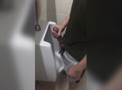 Shows Erect Cock at Urinal