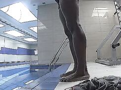 Handsome guy naked in a hotel pool.