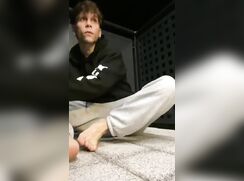 Twink strips naked on public balcony