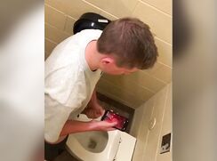 Spying on 2 hunks jerking off in the toilet