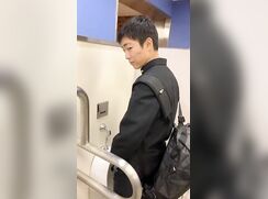 A male student is pissing in the toilet 8.