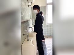 A male student is pissing in the toilet 11.