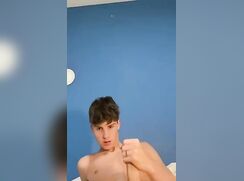 a cute guy in bed wanking big cock