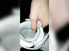 Boy pissing in his sneakers