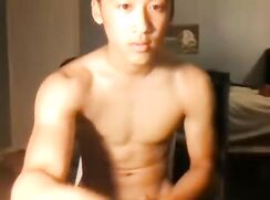Asian muscle boy wanks and cums on chair porn