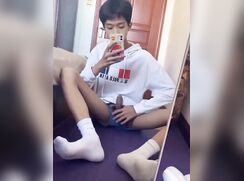 boy playing alone in front of the mirror