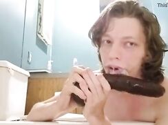 Deepthroating a huge dildo