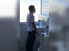 A male student is pissing in the toilet 7