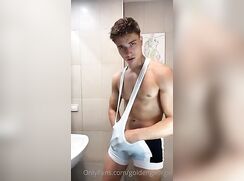 golden wrestler guy striping with a hard on