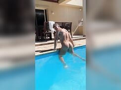 Twink in pool showing his bum