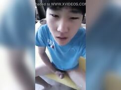 Asian teen in blue clothes wanking