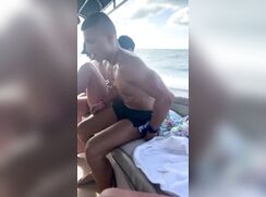 Straight Lad with semi changing on boat in front off everyone