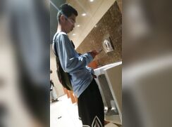 A male is pissing in the toilet public porn