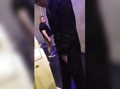 A male is pissing in the toilet 4