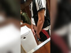 A male is pissing in the toilet 6