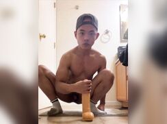 Asian guy fucks his dildo