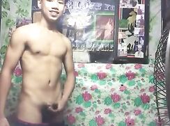 Asian boy with braces wanks and cums next to fan