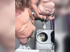 Two jocks pee together