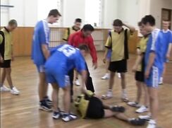 Coach takes care of twink after basketball injury