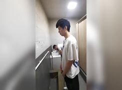 A male is pissing in the toilet 17