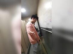 A male is pissing in the toilet 18