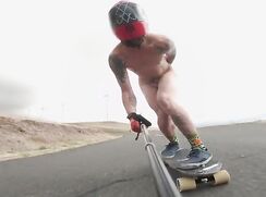 Skateboarding on a down hill road naked