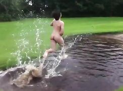 Teen boy having fun naked outdoors in front of friends