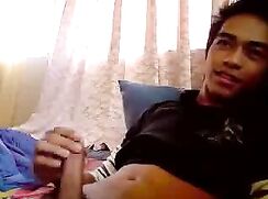 Cute Asian teen boy gets helping hand stroking his boy meat