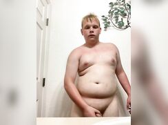 Chubby blonde boy shows off in the bathroom