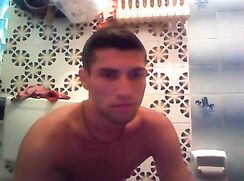 Webcam boy in red shorts with cross necklace