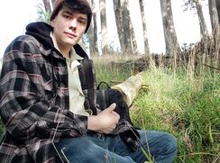 Young guy pulls his uncut cock out and takes a piss in the park