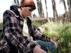 Young guy pulls his uncut cock out and takes a piss in the park