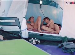 Two guys alone in a tent by the river bank
