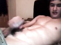 Smiling muscle boy on phone wanks and cums