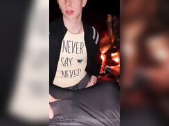 cute blonde guillo heping a frien at beach bonfire