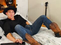 Cowboy Jerks Lying on Bed