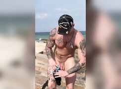 Hot tatted lad changes speedos at the beach