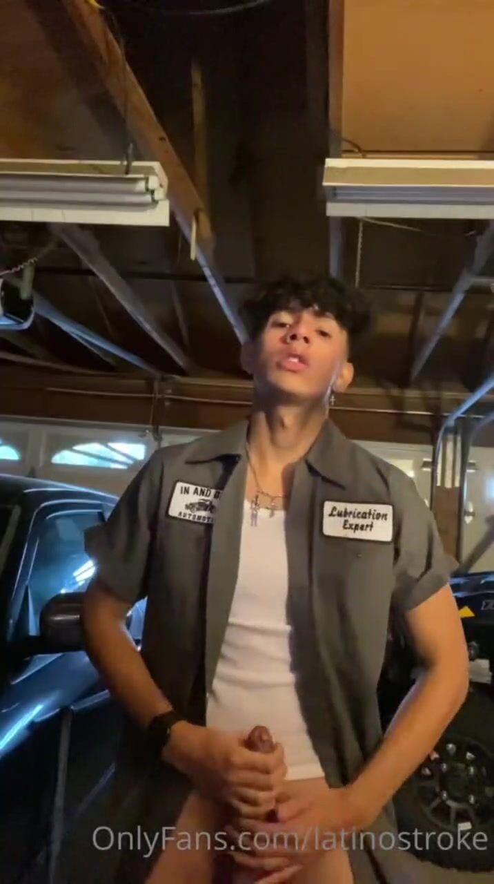 The mechanic showing off his muscles covered in grease