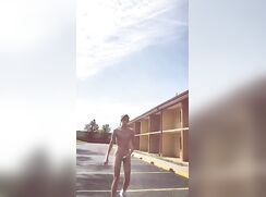 Hard and nude in a vacant parking lot