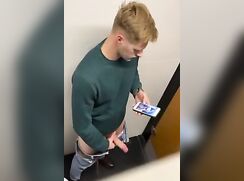Blond guy jerk off in the toilet.