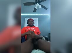 Cute black boy jerking off in his game chair and cums