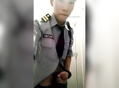 chinese security guard in uniform jerking off in toilet