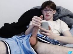 Nerdy Twink Scrolling While Stroking His Big Dick