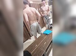 Young guys changing in locker room