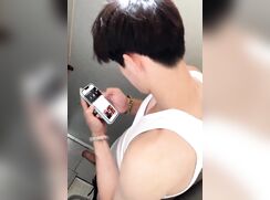 handsome chinese boy stroking in toilet